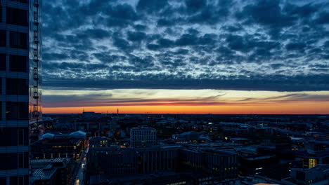 Time-lapse-of-small-clouds-moving-over-the-cityscape-of-Helsinki,-dramatic-dusk