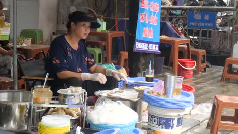 Street-seller-preparing-delicious-traditional-deep-fried-spring-rolls