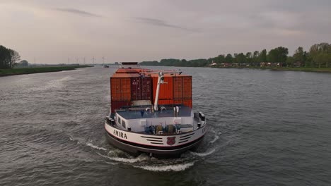 Amira-Shipping-Container-Traveling-Across-The-Waterways-Near-Moerdijk,-Netherlands