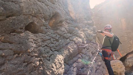 Sportsman-rock-climbing-aerial-view-of-sportsman-rapelling-mountain-in-La-Panocha,-el-Valle-Murcia,-Spain-woman-rapel-down-a-mountain-climbing-a-big-rock