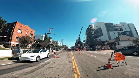 Motorcycle-drive-up-hill-with-construction-cones-on-the-road