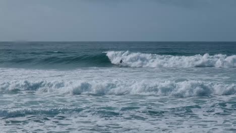 Surfer-riding-a-wave-in-the-Atlantic-Ocean-in-Portugal