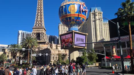 Las-Vegas-USA,-Sunny-Day-on-Vegas-Strip,-Pedestrian-on-Crosswalk-in-Front-of-Paris-Casino-Hotel,-Slow-Motion