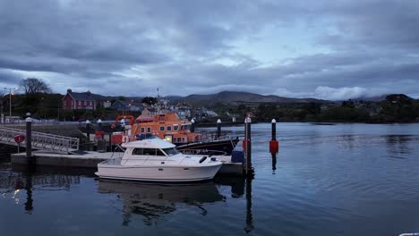 Ireland-Epic-Locations-Castletownbere-Harbour-Cork,-Lifeboat-moored-in-harbour-with-the-town-behind,-just-before-dawn-on-a-summer-morning