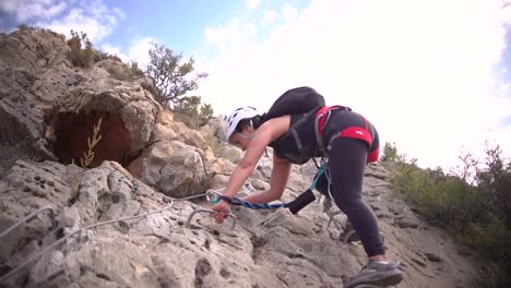 Sportsmen-and-women-rock-climbing-aerial-view-of-sportsman-rapelling-mountain-in-La-Panocha,-el-Valle-Murcia,-Spain-woman-rapel-down-a-mountain-climbing-a-big-rock