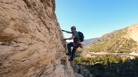 Sportsman-rock-climbing-aerial-view-of-sportsman-rapelling-mountain-in-La-Panocha,-el-Valle-Murcia,-Spain-woman-rapel-down-a-mountain-climbing-a-big-rock