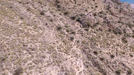 Sportsmen-ziplining-aerial-view-of-sportsman-in-zipline-amidst-mountain-in-Murcia,-Spain