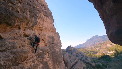 Sportsman-rock-climbing-aerial-view-of-sportsman-rapelling-mountain-in-La-Panocha,-el-Valle-Murcia,-Spain-woman-rapel-down-a-mountain-climbing-a-big-rock