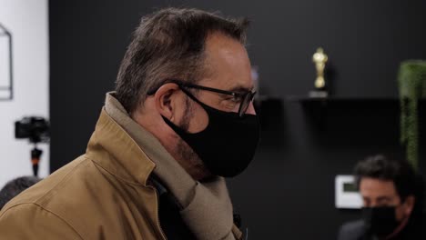 Close-up-shot-of-a-man-wearing-a-face-mask-at-a-business-conference