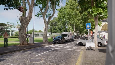 Old-cobblestone-road-with-crosswalk,-Funchal-cable-car-in-background,-Madeira