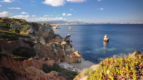 Scenic-coastal-view-of-Praia-do-Camilo-in-Lagos,-Portugal-during-a-sunny-day,-timelapse