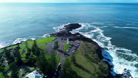 Drone-aerial-landscape-view-of-carpark-roads-of-Kiama-blowhole-with-lighthouse-harbour-carpark-rocky-point-headland-coastline-South-Coast-tourism-Australia-travel