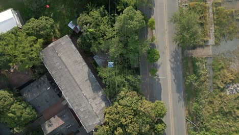 Cali-Colombia-Drone-Aerial-Top-Down-View-Cable-Cars-Moving-Over-Trees-at-Sunset