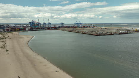 Aerial-of-a-coastal-industrial-port-with-large-cargo-containers-and-cranes