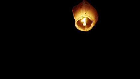 lose-up-view-of-a-single-sky-lantern-glowing-brightly-against-a-dark-night-sky