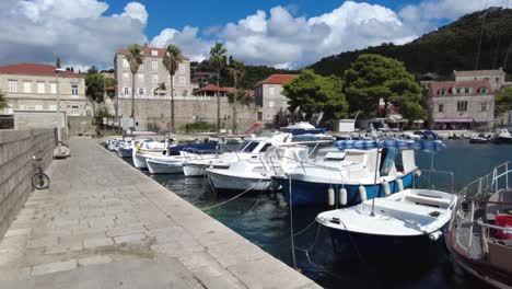 Boats-docked-at-a-serene-harbor-on-the-Elafiti-Islands-in-Croatia-during-a-sunny-day