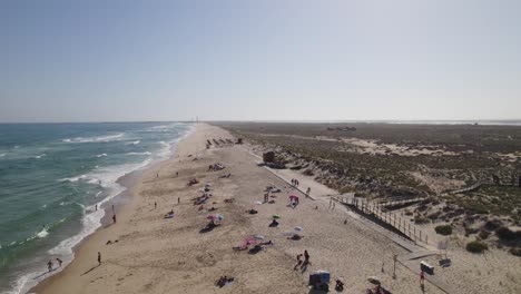 People-enjoying-a-sunny-day-on-culatra-island-beach,-Olhao-Portugal,-aerial-view