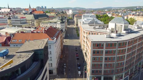 Brno-city-street-and-downtown-buildings,-aerial-drone-fly-forward-view