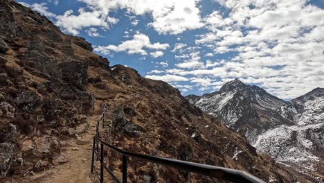 View-of-hike-along-railing-high-in-the-Himalayan-mountains-of-Gosaikunda,-Mountain-pass-trek