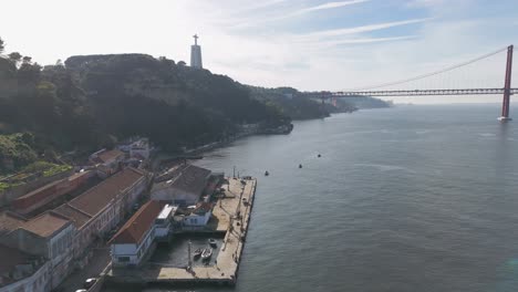 Aerial-tracking-shot-of-the-Cais-do-Ginjal-viewpoint,-in-sunny-Lisbon,-Portugal