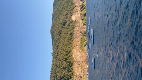 Serene-view-of-boats-on-a-calm-lake-with-a-forested-mountain-backdrop-in-Argentinian-Patagonia