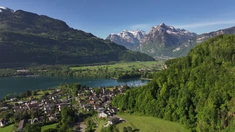 Aerial-footage-of-Walensee,-a-picturesque-lake-in-Switzerland,-surrounded-by-the-villages-of-Wessen,-Amden,-Quinten,-and-Mols