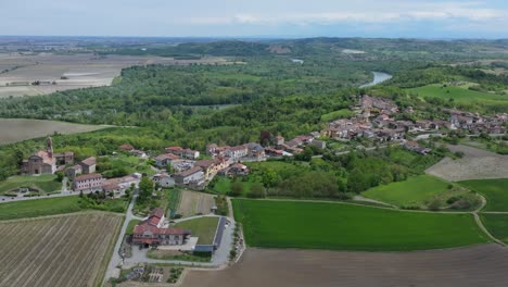 aerial-journey-to-the-beautiful-hillside-town-of-Camino,-centuries-old-medieval-village-in-Piedmont,-Italy