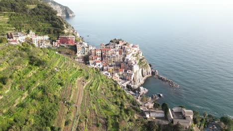 Manarola-Cinque-Terre-Italy-aerial-pullback-reveal-on-sunny-day