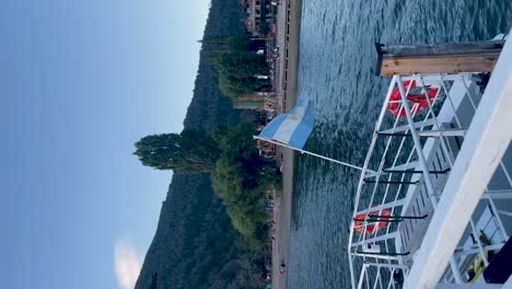 Boat-docked-at-serene-lake-in-Argentinian-Patagonia-with-mountainous-background-during-calm-evening