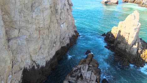 Aerial-view-of-sea-lions-resting-on-a-rock-on-a-sunny-day-in-Los-Cabos