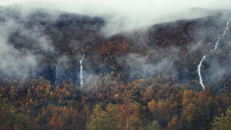 Majestuosas-Cascadas-Caen-Por-Los-Acantilados,-Rodeadas-Por-Un-Bosque-Otoñal-A-Todo-Color