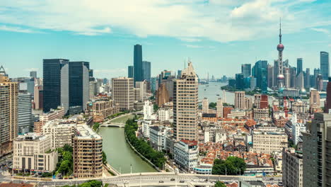 Urban-atmosphere,-Suzhou-River-Waibaidu-Bridge-surrounded-by-historical-Shanghai-buildings-against-skyscrapers-landmark-tower-under-blue-sky-architectural-scenery-time-lapse-in-China