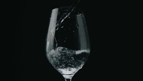 Pouring-water-in-elegant-glass-in-slowmotion