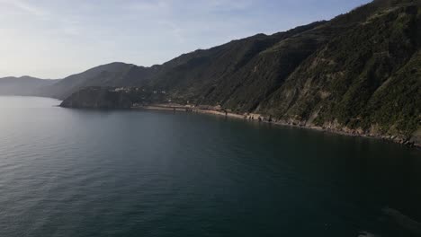 Manarola-Cinque-Terre-Italy-aerial-tilt-up-of-ocean-and-mountains