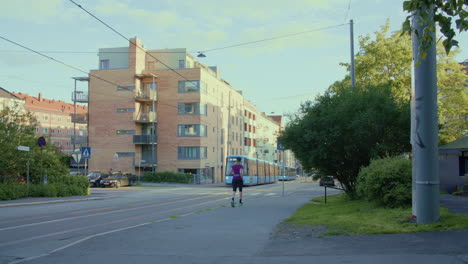 Two-trams-passing-by-with-pedestrians-walking-in-Oslo