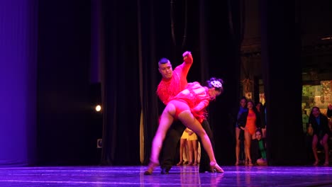 Hispanic-Couple-Salsa-Dancing-And-Doing-Acrobatic-Tricks-On-Stage