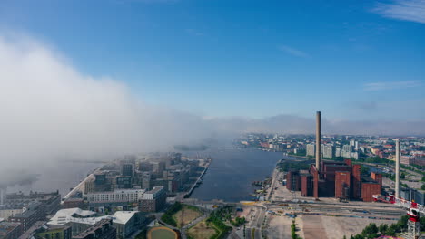 Timelapse-of-thick-mist-moving-over-the-Helsinki-skyline,-summer-day-in-Finland