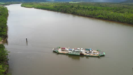 Aerial-View-of-Ferry-Boat-Transportation-Connecting-Daintree-Riverbanks-and-Rainforest,-Queensland,-Australia