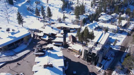 Olympic-Valley,-Lake-Tahoe-USA,-Aerial-View-of-Buildings-and-Ski-Lift-Gondolas-on-Sunny-Winter-Day