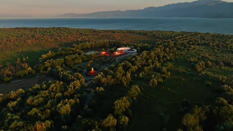 Aerial-view-circling-the-Plavnica-Eco-Resort,-sunset-in-Skadar-lake,-Montenegro