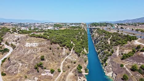 Narrow-water-channel,-bridge-connections,-vegetation,-natural-environment