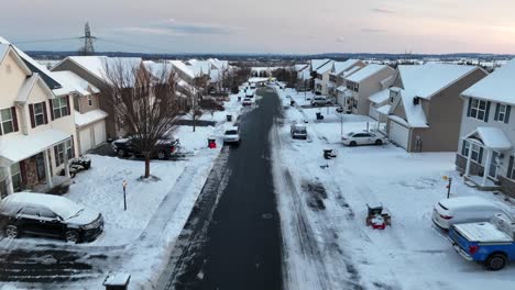 Aerial-birds-eye-shot-over-snowy-homes-and-Buildings-in-american-Suburb