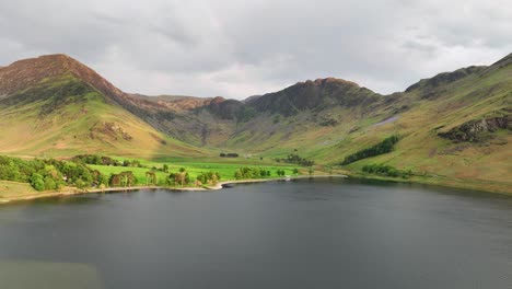 Vista-Aérea-Sobre-El-Lago-Buttermere-En-Una-Tarde-De-Primavera,-Con-Arco-Iris,-Cumbria,-Inglaterra