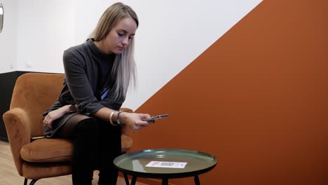 Slow-motion-shot-of-a-woman-scanning-a-QR-code-on-a-table-to-sign-in