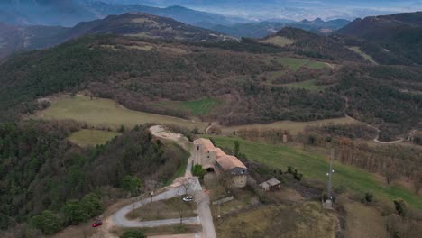 Church-of-sant-pere-de-casserres-and-surrounding-landscape,-serene-rural-scene,-aerial-view