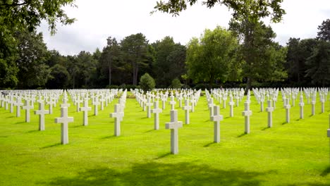 A-tracking-shot-showing-rows-of-white-crosses-of-fallen-soldiers-at-the-Normandy-American-Cemetery-and-Memorial-near-Omaha-Beach,-France