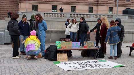 Fridays-For-Future-Protesters-With-Placards-At-Parliament-House-In-Stockholm,-Sweden,-Static-Shot