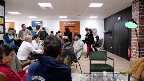 Slow-establishing-shot-of-people-networking-at-a-corporate-bowling-event