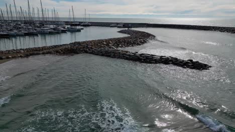 Boats-docked-at-port-ginesta-in-barcelona-on-a-cloudy-day,-aerial-view