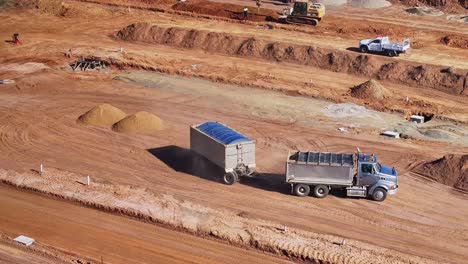 Truck-and-trailer-departing-construction-site-after-tipping-dirt-at-a-construction-site-in-Yarrawonga